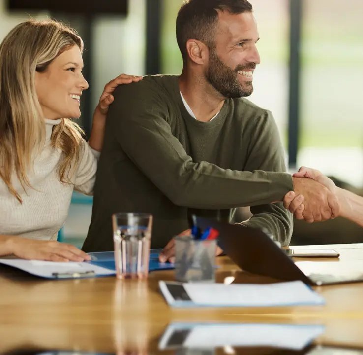 Satisfied clients shaking hands after a meeting