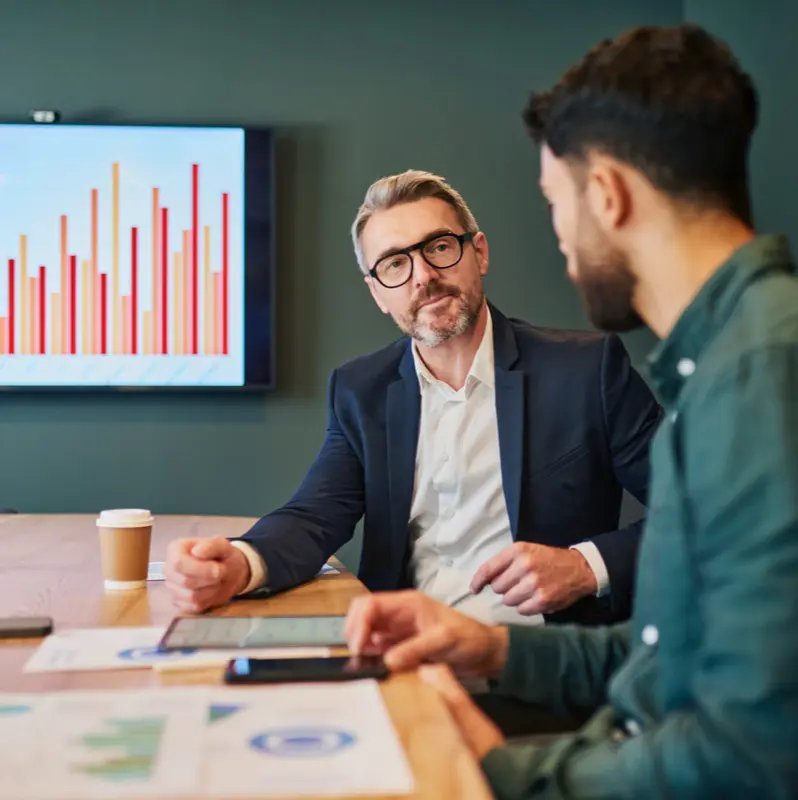 Financial advisors discussing market data