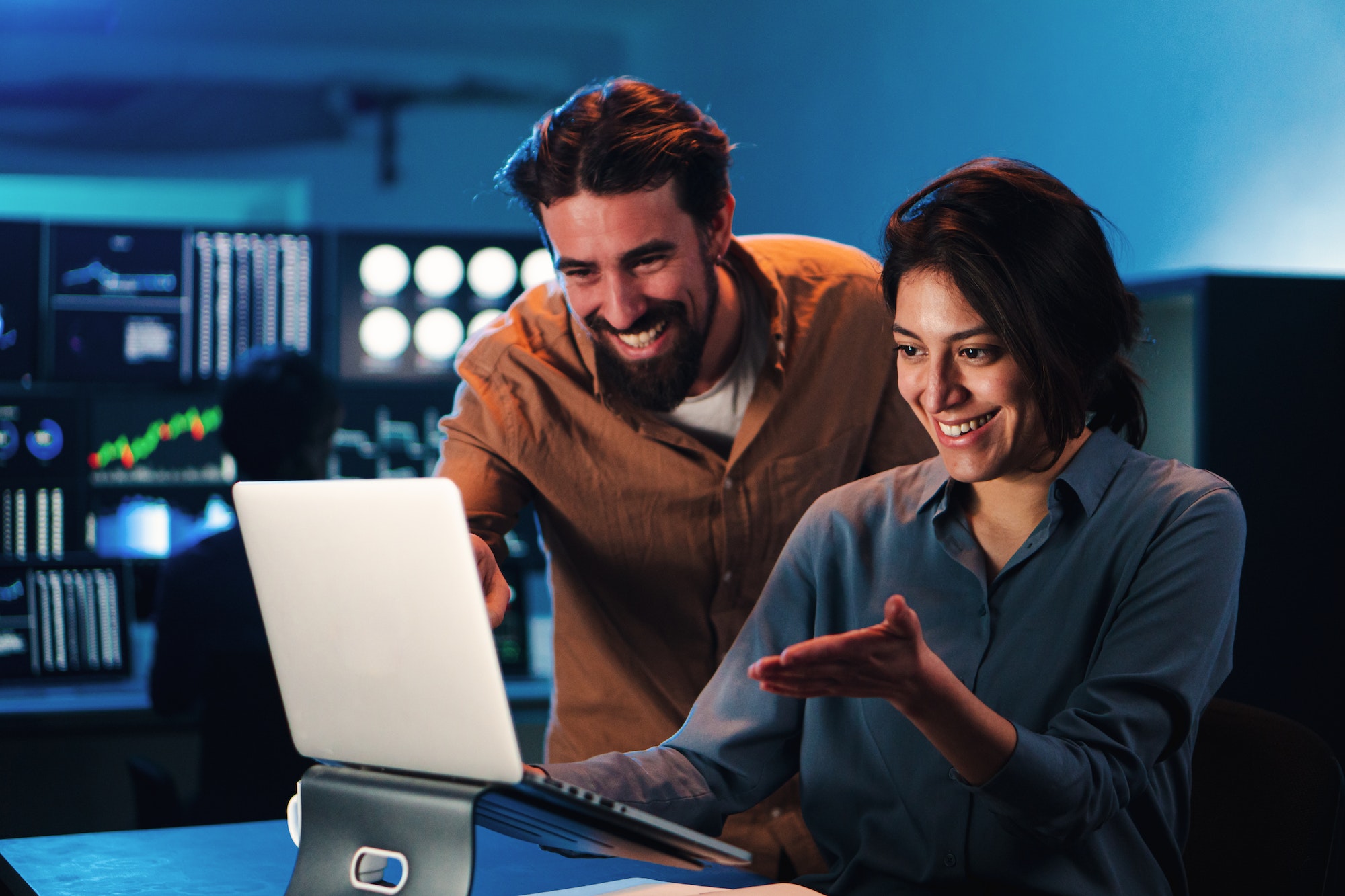 Couple reviewing trading data on a laptop