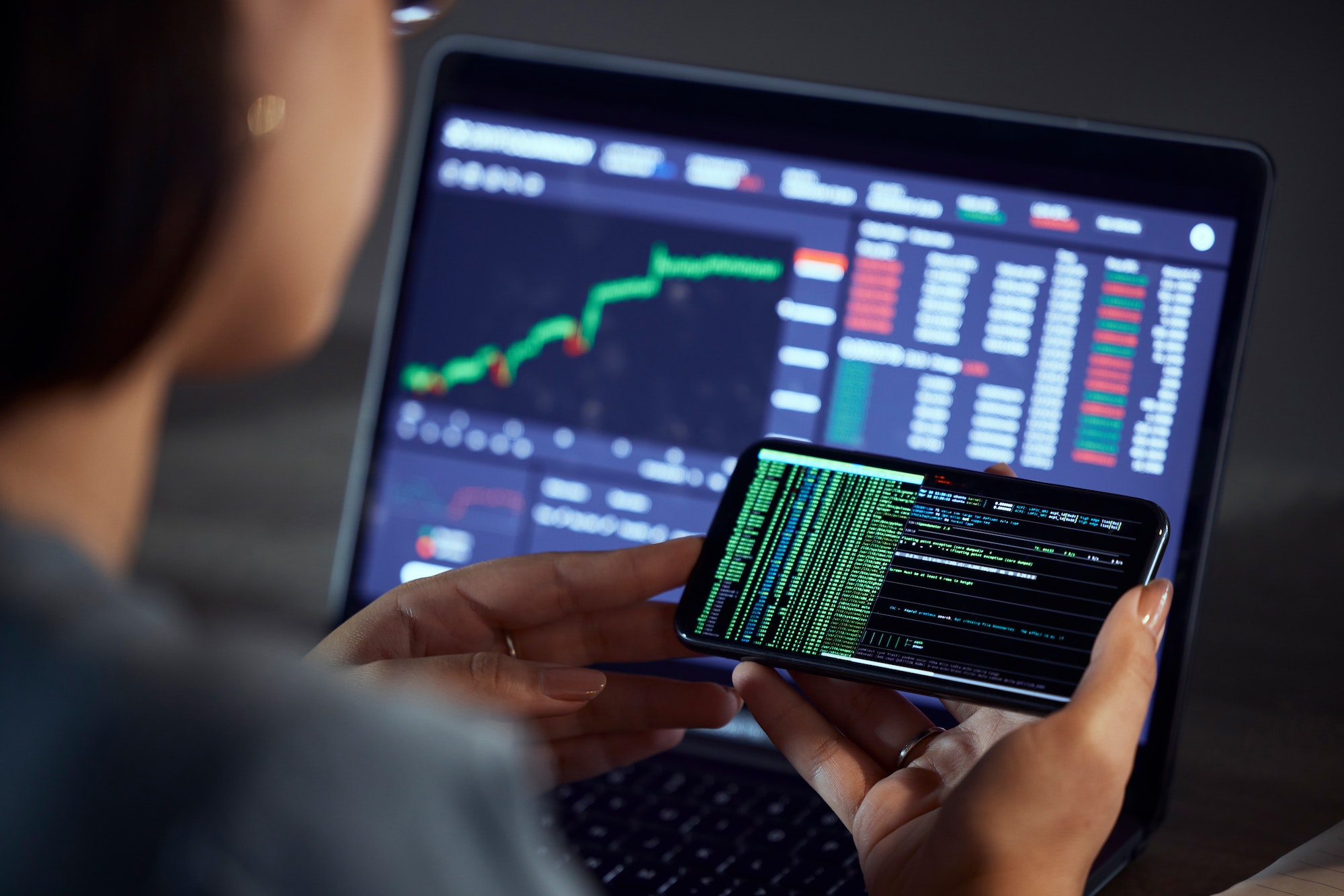 Trader checking a phone at night